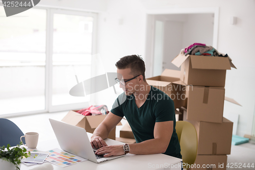 Image of Young man moving in a new home