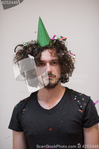 Image of man blowing confetti in the air