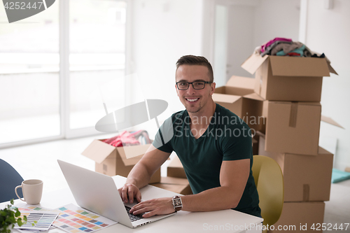 Image of Young man moving in a new home