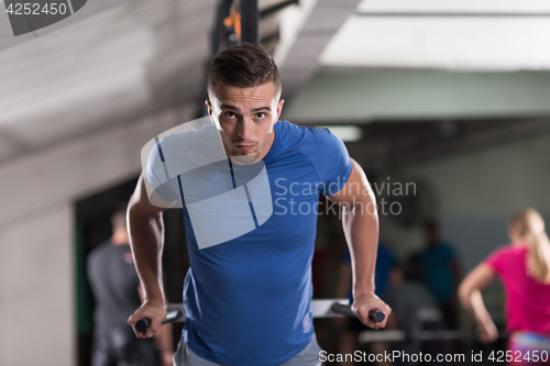 Image of man doing exercises parallel bars