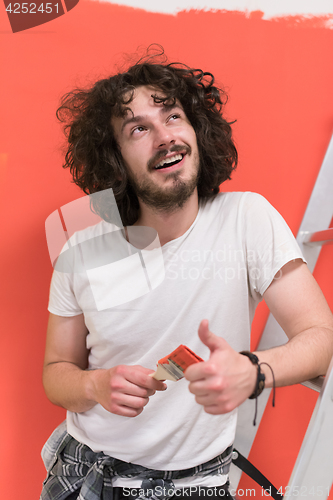 Image of man with funny hair over color background with brush