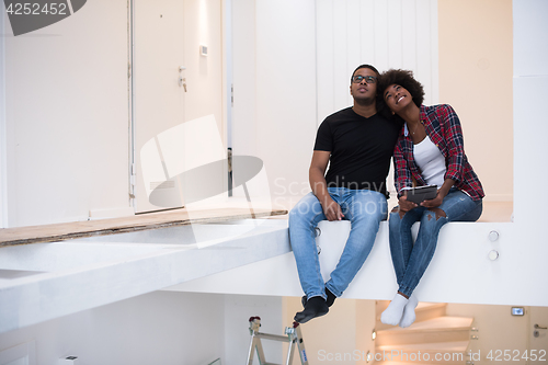 Image of couple having break during moving to new house