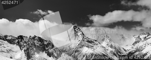 Image of Black and white panorama of snowy mountains in clouds