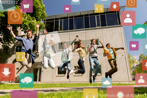 Image of happy teenage students or friends jumping outdoors