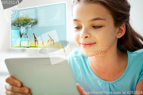 Image of close up of smiling girl with tablet pc at home