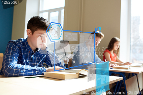 Image of group of students with books writing school test