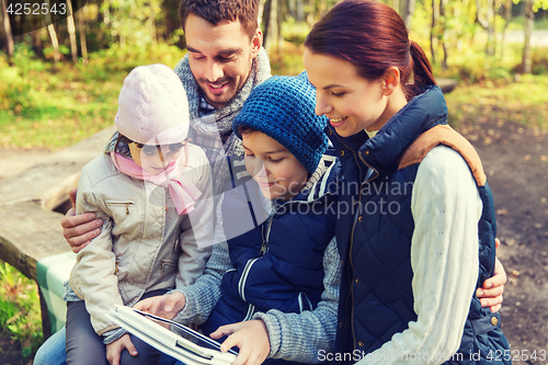 Image of happy family with tablet pc at camp