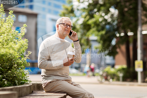 Image of happy senior man calling on smartphone in city