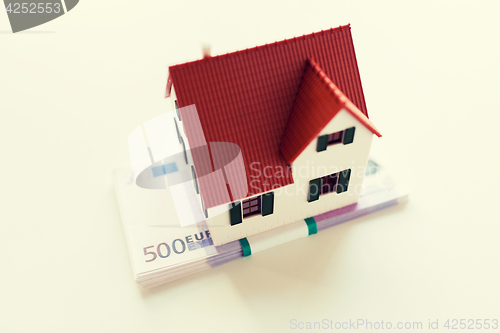 Image of close up of home or house model and money