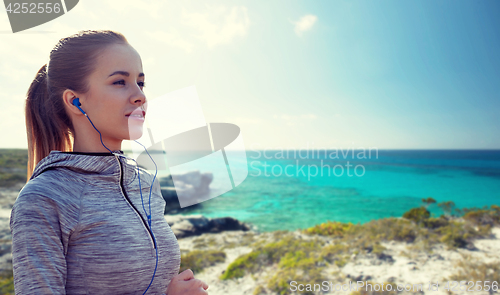 Image of happy woman with earphones running