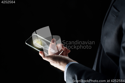 Image of businessman with lightbulb on smartphone