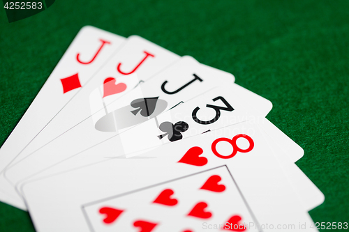 Image of poker hand of playing cards on green casino cloth