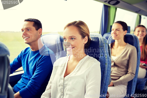 Image of group of happy passengers in travel bus