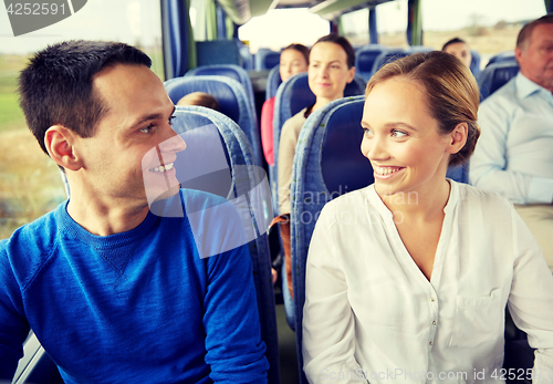 Image of group of happy passengers in travel bus