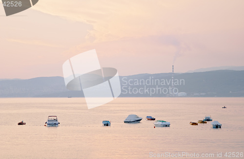 Image of Sea boats at sunset from Omisali,  Rijeca (Fiume) and Bakar refinery in the background, Krk island, Dalmatia, Croatia