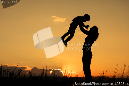 Image of Mother and son playing on the coast of lake