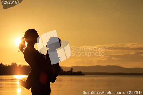 Image of Mother and son playing on the coast of lake