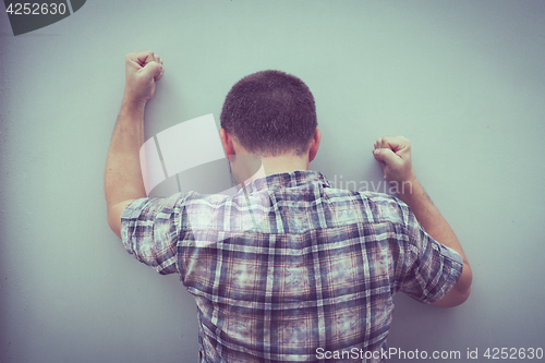 Image of portrait one sad man standing near a wall 