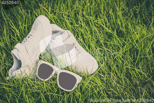 Image of youth sneakers on the grass