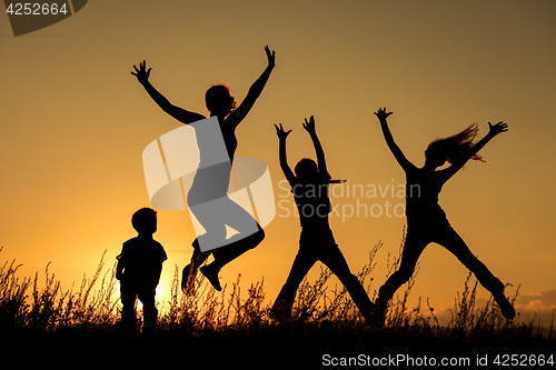 Image of Happy family standing in the park.