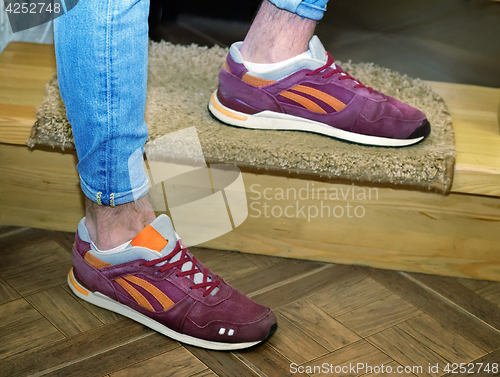 Image of Young man in sneakers and jeans