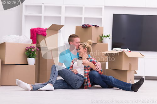 Image of young couple moving  in new house