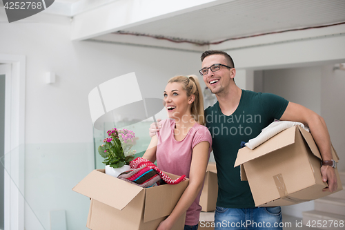 Image of young couple moving into a new home