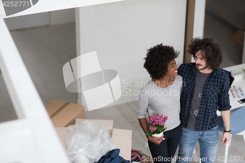 Image of multiethnic couple moving into a new home