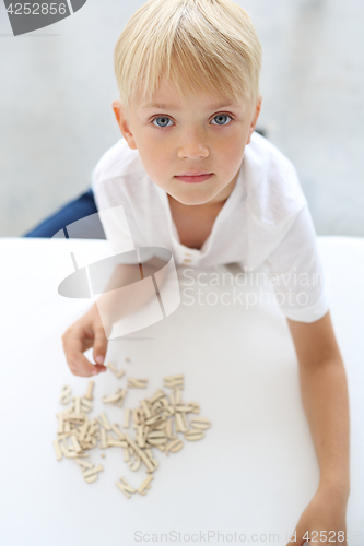Image of Learning to write. The child puts words with letters.