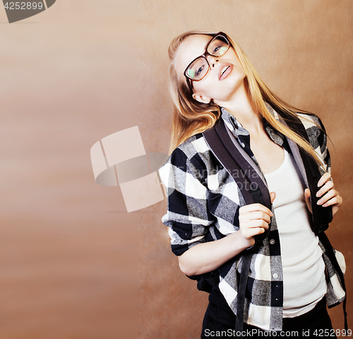 Image of young happy smiling hipster blond girl with backpack ready to sc