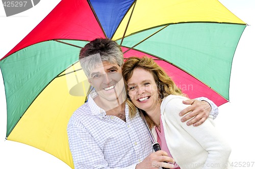 Image of Happy mature couple with umbrella