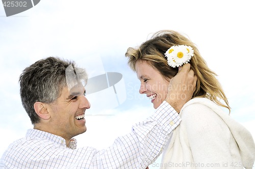 Image of Mature romantic couple with flowers