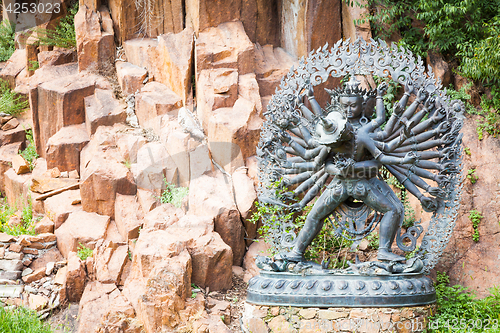 Image of Tantric Deities statue in Ritual Embrace located in a mountain g