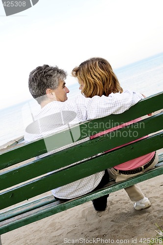 Image of Mature romantic couple on a bench