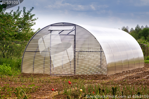 Image of A small greenhouse in the garden.