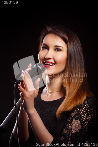 Image of Girl with microphone in studio