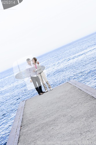 Image of Mature romantic couple on a pier