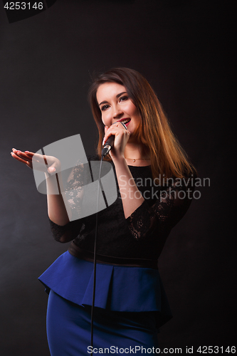 Image of Long haired woman with microphone