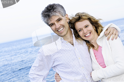 Image of Mature romantic couple at seashore