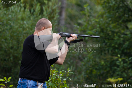 Image of the shooter aiming from a gun at target