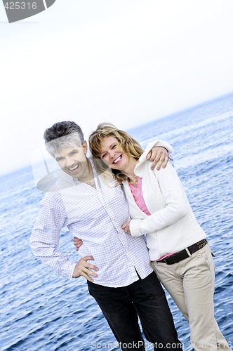Image of Mature romantic couple at seashore