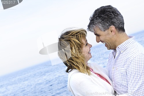 Image of Mature romantic couple at seashore