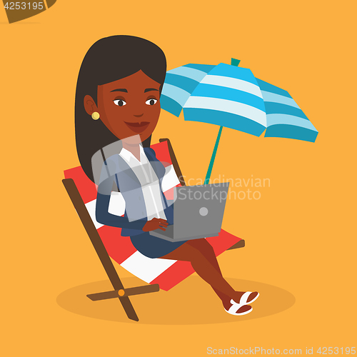 Image of Businesswoman working on laptop at the beach.