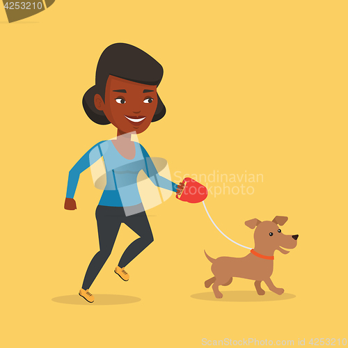 Image of Young woman walking with her dog.