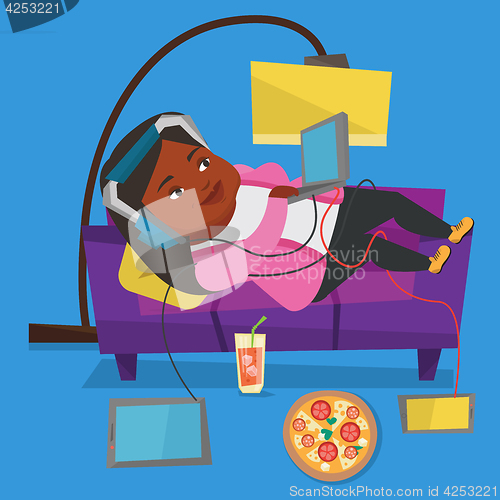 Image of Woman lying on sofa with many gadgets.