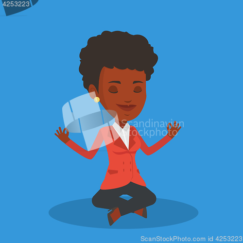 Image of Business woman meditating in lotus position.