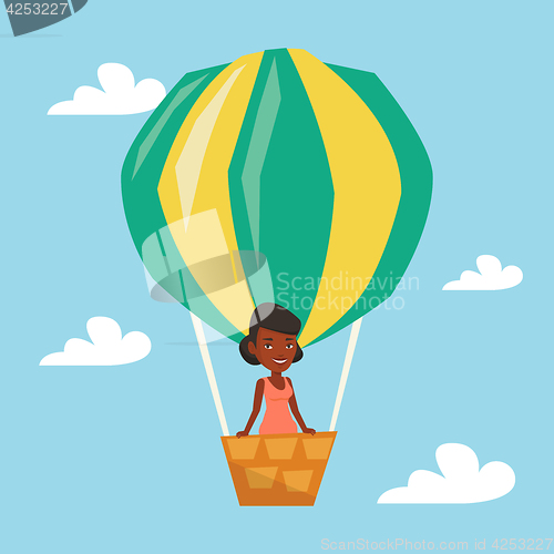 Image of Woman flying in hot air balloon.