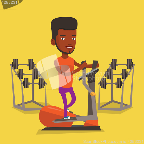 Image of Man exercising on elliptical trainer.