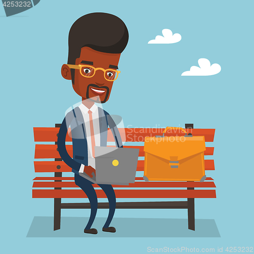 Image of Businessman working on laptop outdoor.