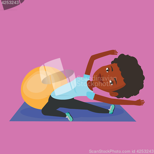 Image of Young woman exercising with fitball.